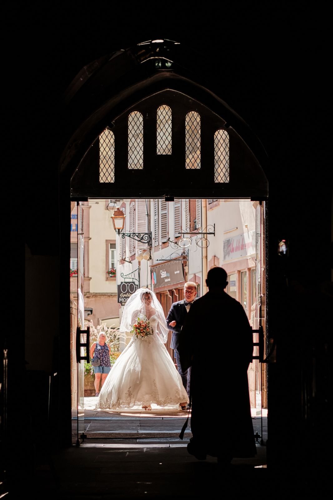 La mariée en silhouette dans le portail gothique de l’église Notre-Dame de la Nativité de Saverne